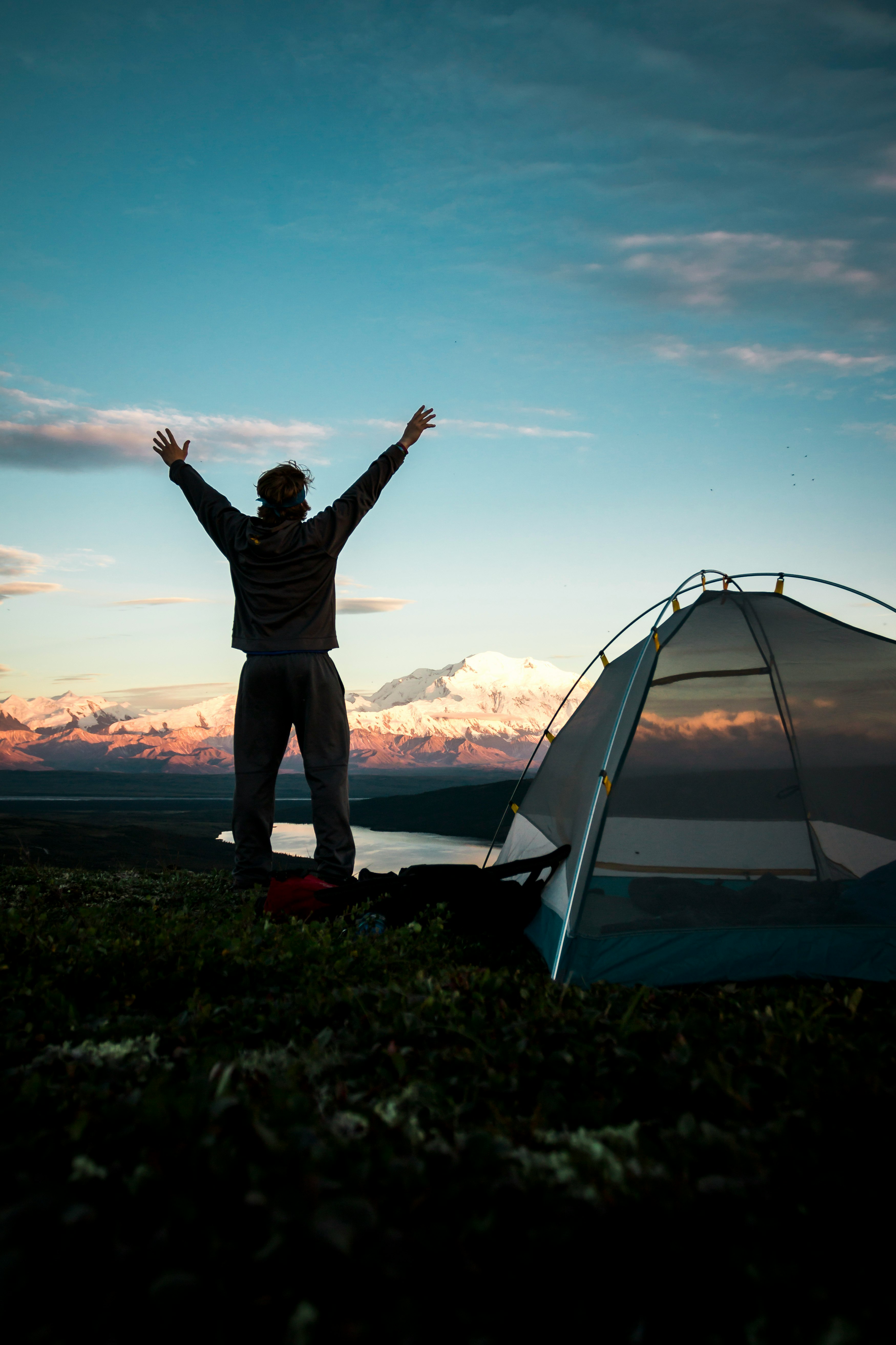 person beside gray tent